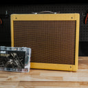 tweed deluxe guitar amplifier with a amp kit on a workbench
